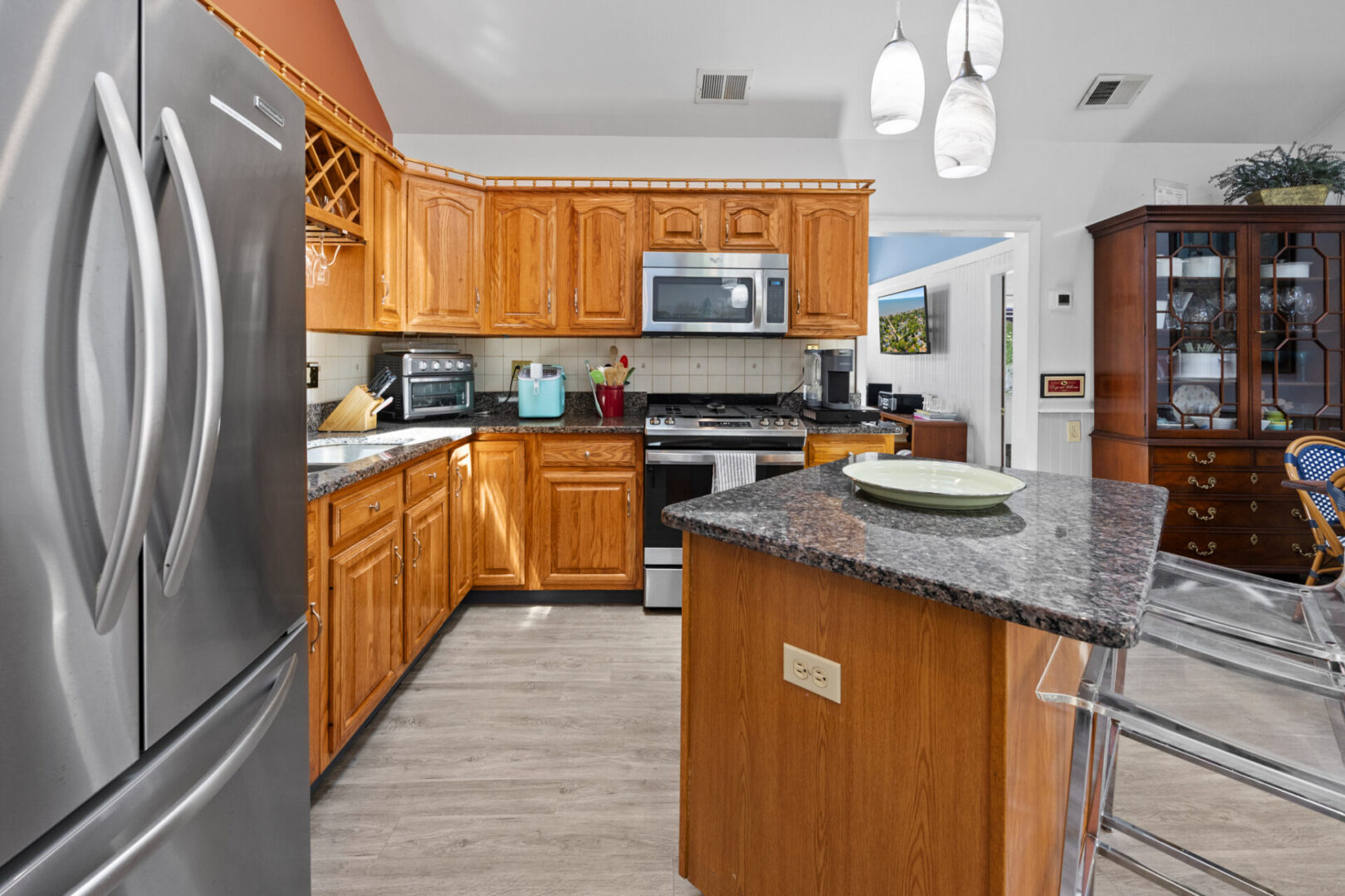 Modern kitchen with wooden cabinets and granite countertops.
