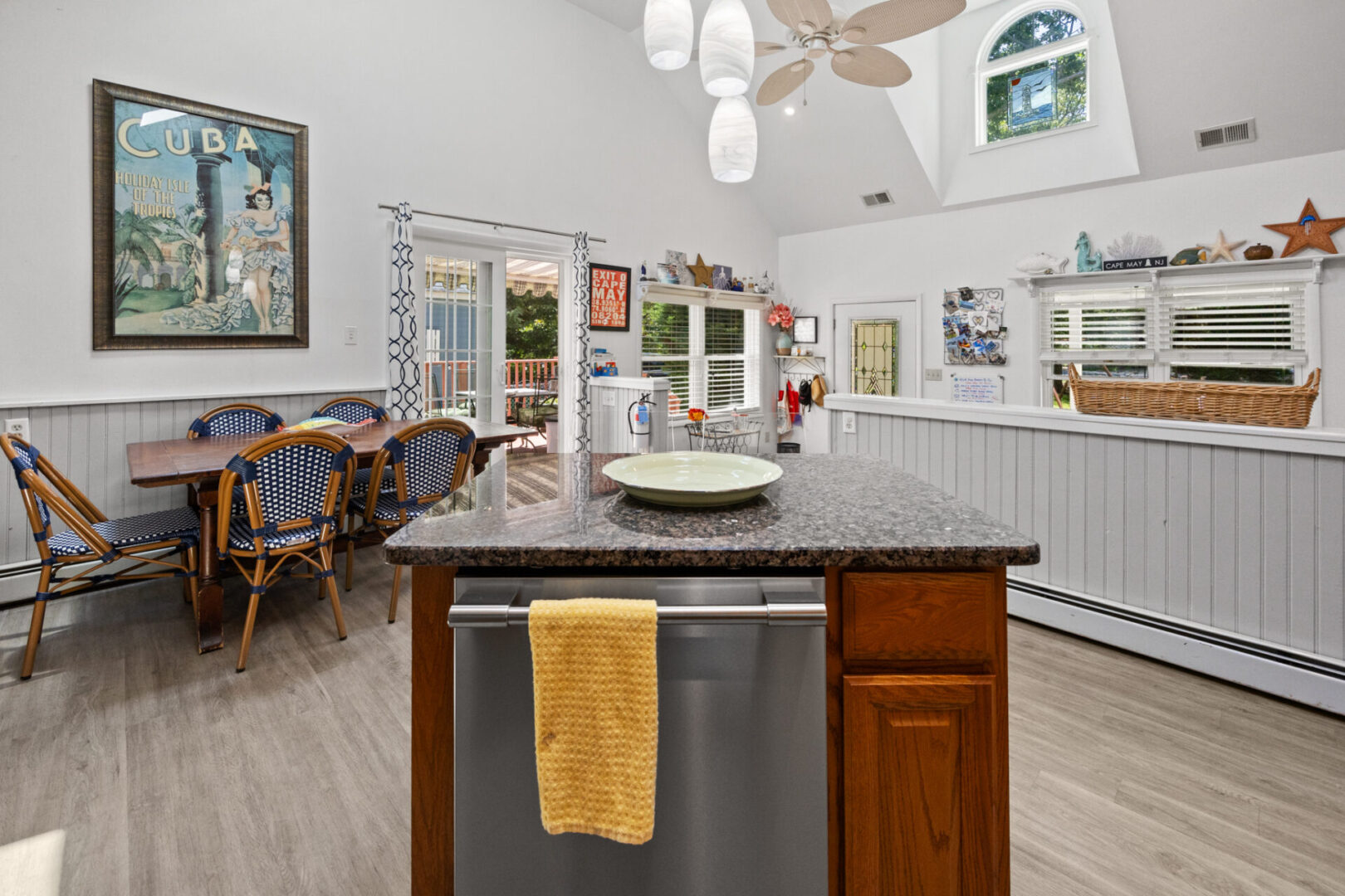 Cozy kitchen with a large island, bar stools, and white cabinetry.