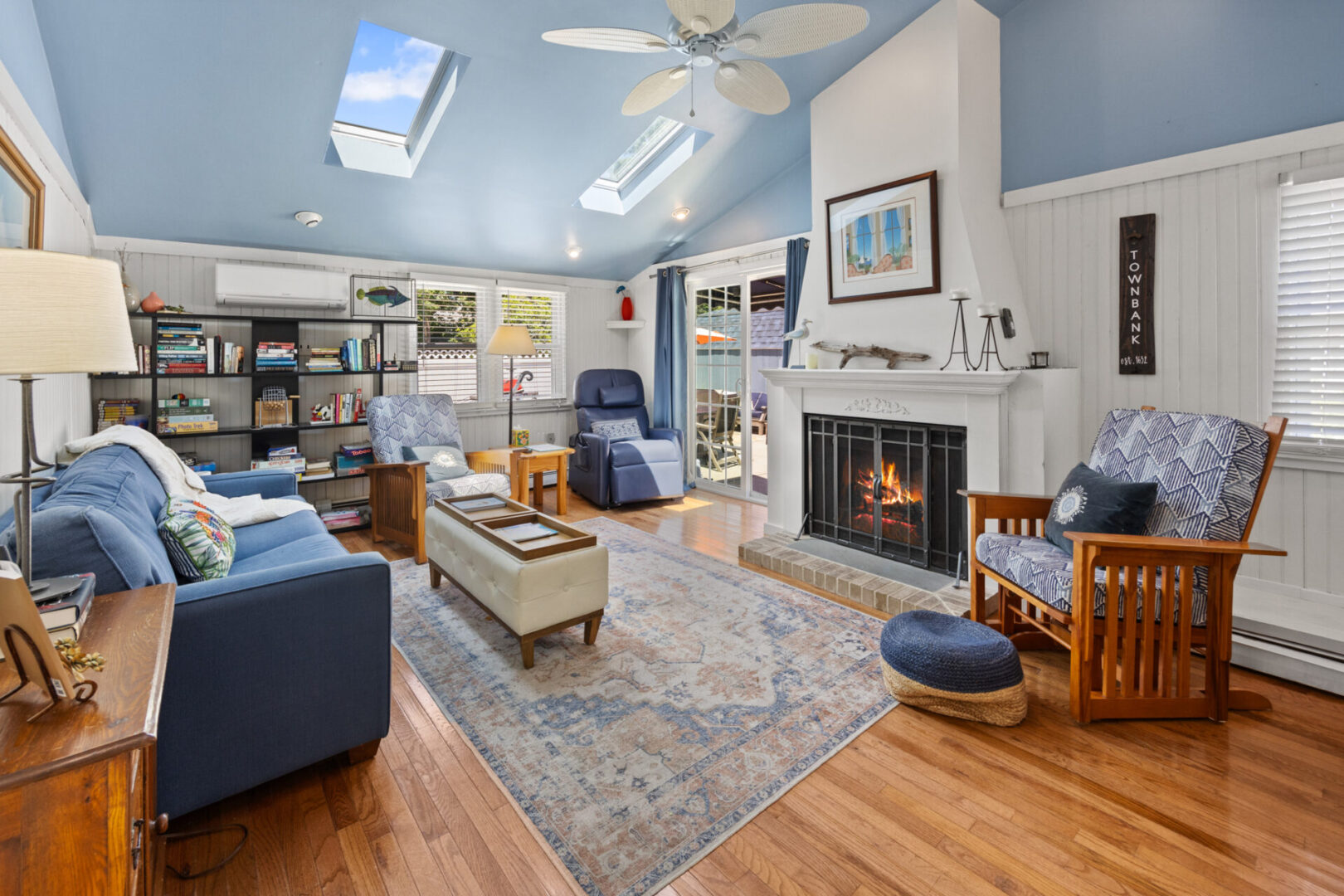 Cozy living room with blue walls and a fireplace.
