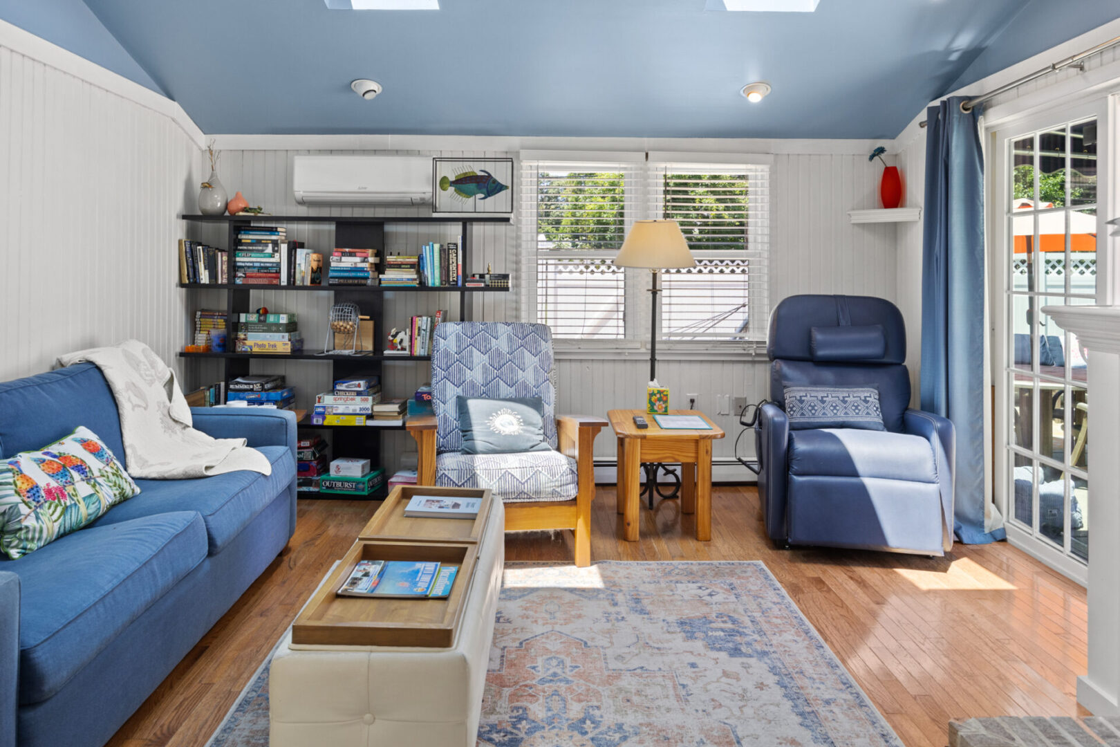 Comfortable living room with various seating and a bright window.