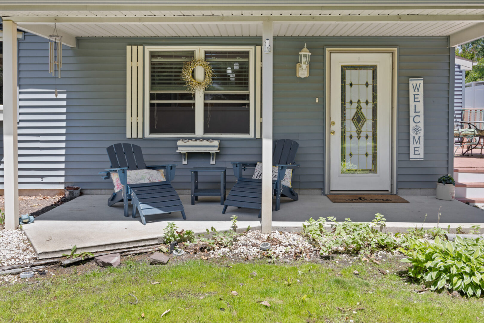 Cozy front porch with rocking chairs and a decorated door.